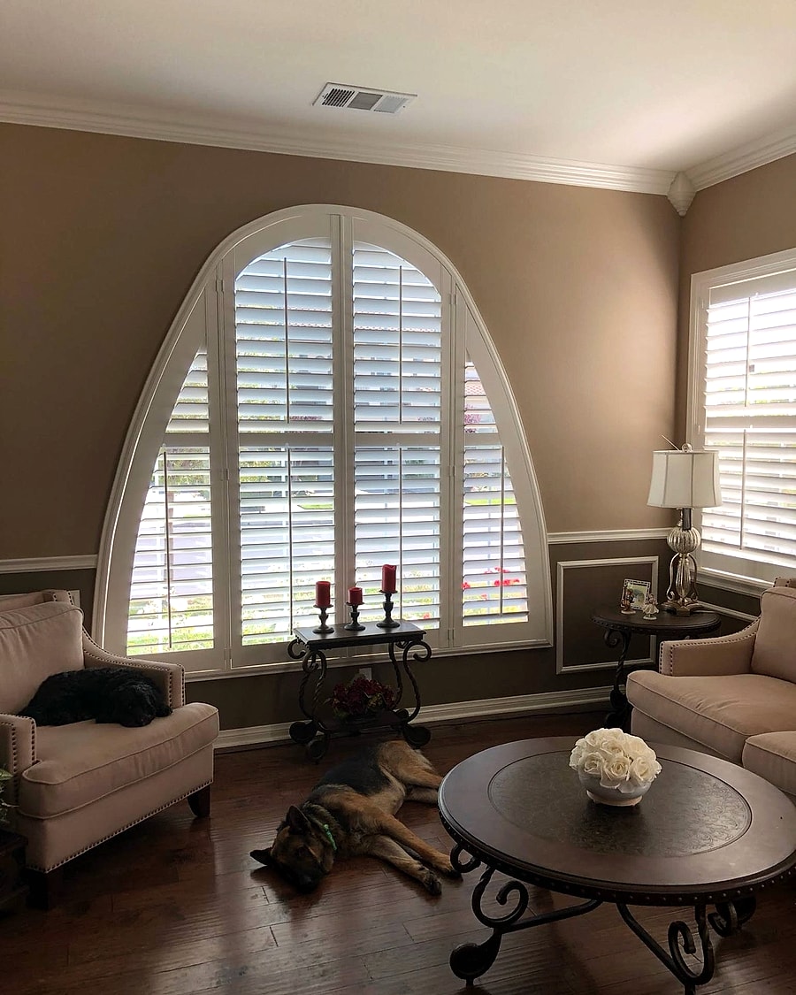 Custom arched plantation shutters in a Ventura County living room