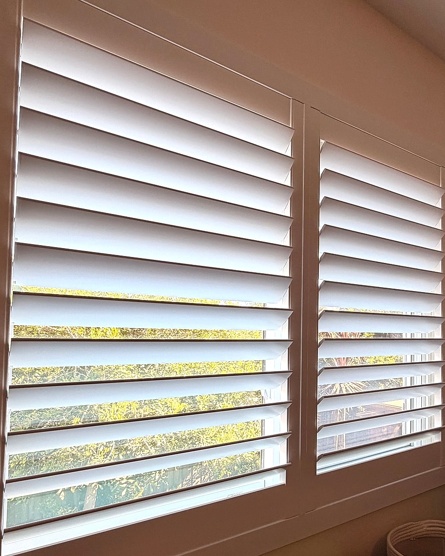 White plantation shutters installed on a Ventura County bedroom window