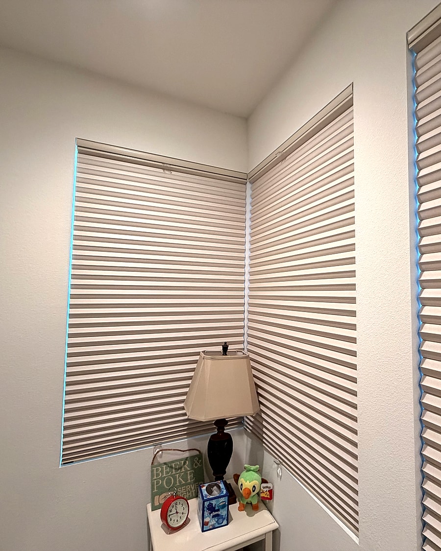 Cellular shades installed across a corner room window grouping