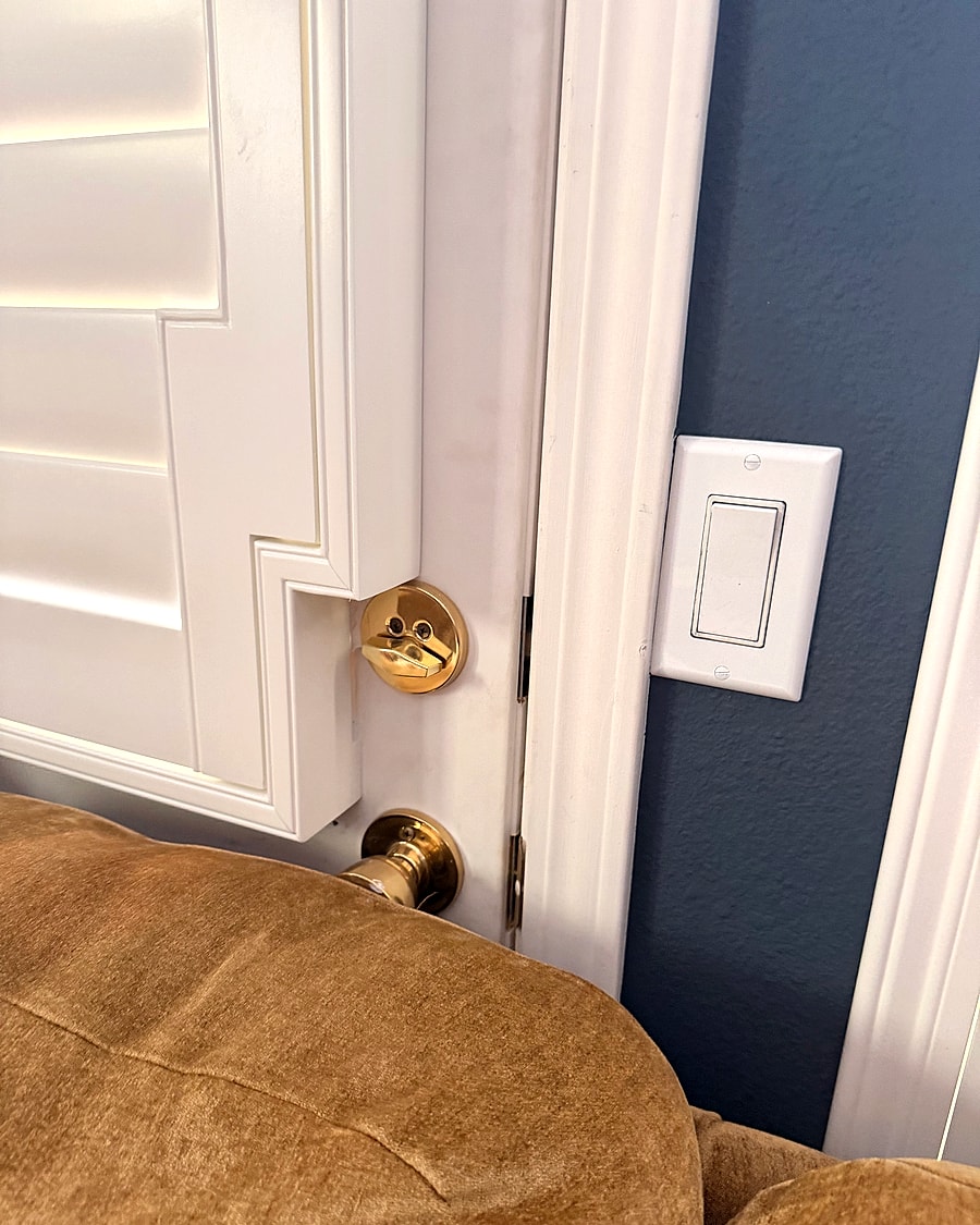 Close detail of a custom shutter panel beside a door in a Ventura County home